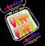 Colorful nail art tips in a clear container with 'Angel' branding on a black background.