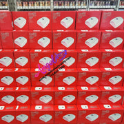 Stack of red and white boxes with a brand logo on a gray floor.